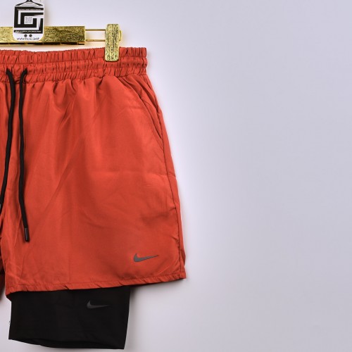 شورت رياضي مدمج بستريج قصير يغطي نصف الساق فصال اكثر من رائع  nike للجنسين برتقالي واسود